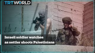 Israeli soldiers seen standing by and watching as settlers shoot Palestinians