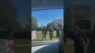 Neo Nazis â€” displaying swastikas and other  paraphernalia on the side of a road