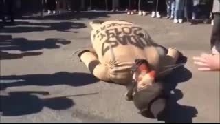 Polish people and kids beating a Jewish mannequin