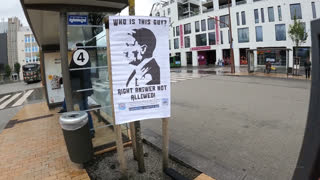 Some Hitler posters at the bus stop. next to a couple of boomers