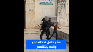 Palestinian child panics while Israeli forces are attacking his father in the courtyard of Al-Aqsa m