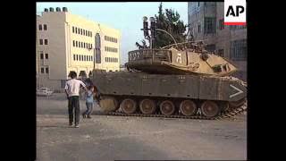 Youths throw stones at Israel Tank