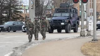 Windsor protest. Cops brandishing military gear, driving armored vehicles