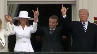 Trump & Melania hold hands through Emmanuel Macron - Who has to make devil horns.